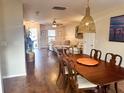 Open concept dining room and living room with hardwood floors at 8781 Red Oak Dr, North Charleston, SC 29406