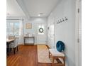 Bright entryway with hardwood floors, bench, and coat hooks at 9159 Parlor Dr, Ladson, SC 29456