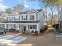 Two story townhome with gray siding, front porch, and driveway at 9159 Parlor Dr, Ladson, SC 29456