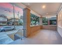 Spacious front porch with brick pillars and a view of the street at 929 Rutledge Ave, Charleston, SC 29403
