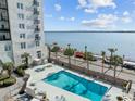 Refreshing swimming pool with palm trees and water views at 1 King St # 503, Charleston, SC 29401