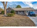 Brick ranch house with front porch and landscaping at 100 Wigwam Way, Summerville, SC 29486