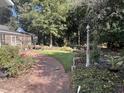 Landscaped backyard with a curved pathway and garden at 109 Quaker Rd, Saint George, SC 29477