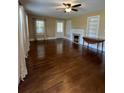 Spacious living room featuring hardwood floors, fireplace, and built-in shelves at 109 Quaker Rd, Saint George, SC 29477