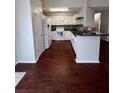 Kitchen with white cabinets, granite countertops, and hardwood floors at 139 Blue Jasmine Ln, Summerville, SC 29483