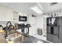 Modern kitchen with black appliances and granite counters at 14 Lockwood Dr # 6H, Charleston, SC 29401