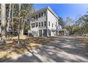 Two-story house exterior showcasing gray siding, large windows, and a wraparound porch at 1461 Lieben Rd, Mount Pleasant, SC 29466