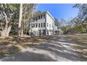 Two-story house exterior with gray siding, large windows, and a gravel driveway at 1461 Lieben Rd, Mount Pleasant, SC 29466