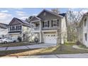 Two-story house with a gray exterior, white trim, and a two-car garage at 153 Instructor Ct, Ladson, SC 29456