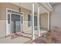 Inviting front entrance with a dark gray door, white columns, and a small porch at 157 Spring Meadows Dr, Summerville, SC 29485