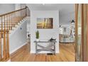 Bright entryway with hardwood floors and coastal decor at 1661 Battalion Dr, Charleston, SC 29412