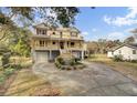 Two-story house with double garage, large porch, and landscaped yard at 1661 Battalion Dr, Charleston, SC 29412