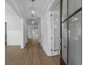 Elegant hallway features wood flooring, white trim, and stylish pendant lighting at 1892 Grover Rd, Johns Island, SC 29455