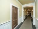 Building hallway with wood door and carpet at 2244 Ashley Crossing Dr # 333, Charleston, SC 29414