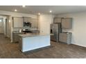 Modern kitchen with gray cabinets, granite countertops, and stainless steel appliances at 229 Grand View Xing, Summerville, SC 29483