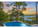 Stunning pool and deck at sunset with marsh views at 26 Cormorant Island Ln, Kiawah Island, SC 29455