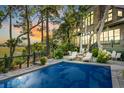 Luxury pool and deck at sunset, adjacent to home at 26 Cormorant Island Ln, Kiawah Island, SC 29455