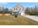 Tan two-story house with a covered porch and landscaped yard at 3043 Mapleleaf Dr., Moncks Corner, SC 29461