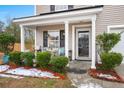 Inviting front porch with seating area and potted plants at 3043 Mapleleaf Dr., Moncks Corner, SC 29461