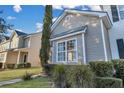 Tan colored siding townhome with a large window at 329 Flyway Rd, Goose Creek, SC 29445