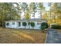 White brick ranch house with a spacious yard and trees at 411 Constance St, Walterboro, SC 29488