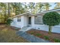 White brick ranch house with updated front entrance and landscaping at 411 Constance St, Walterboro, SC 29488