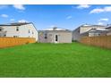 Spacious backyard with a large grassy area and wooden privacy fence at 415 Broad Elm Way, Summerville, SC 29486