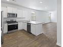 Modern kitchen with white cabinets, granite countertops, and stainless steel appliances at 415 Broad Elm Way, Summerville, SC 29486