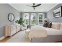 Spacious main bedroom with large windows, neutral decor, and ample natural light at 457 Eagleview Dr, Moncks Corner, SC 29461