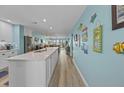 Spacious kitchen with white cabinets, granite countertops, and stainless steel appliances at 48 Mariners Cay Dr, Folly Beach, SC 29439