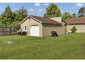 Detached garage with a white door and large yard at 506 Gross Ave, Moncks Corner, SC 29461