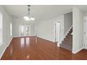 Spacious living room featuring hardwood floors and lots of natural light at 5211 Fernland Way, North Charleston, SC 29420