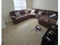 Spacious living room featuring a large sectional sofa and tile flooring at 6884 Shahid Row, North Charleston, SC 29418