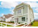 Light green house with white trim and a white picket fence at 729 Opal Wing St, Moncks Corner, SC 29461