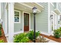 Charming front door entry with a black lantern light at 729 Opal Wing St, Moncks Corner, SC 29461