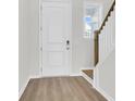 Front entry featuring hardwood floors and white door at 733 Opal Wing St, Moncks Corner, SC 29461