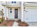 House exterior featuring a black front door, and white siding at 733 Opal Wing St, Moncks Corner, SC 29461
