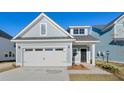 Two-story house with gray siding, white garage door, and landscaping at 767 Opal Wing St, Moncks Corner, SC 29461