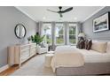 Spacious bedroom with large windows, plush bed, and ample dresser space at 775 Opal Wing St, Moncks Corner, SC 29461