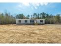 New manufactured home with gray siding, a wooden deck, and ample land at 857 Devines Way, Cross, SC 29436