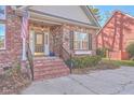Brick front porch with steps and black railing at 8736 Herons Walk, North Charleston, SC 29420