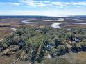 Aerial view of home on a secluded island with marsh and river views at 8934 Sandy Creek Rd, Edisto Island, SC 29438