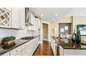 Modern kitchen with white cabinets, granite countertops, and stainless steel appliances at 102 Black Stilt Way, Summerville, SC 29483