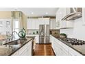 Spacious kitchen with white cabinets, granite countertops, and stainless steel appliances at 102 Black Stilt Way, Summerville, SC 29483