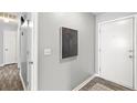 Bright entryway with grey walls, wood-look floors and a modern painting at 109 Salem Ct, Summerville, SC 29486