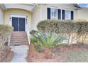 Brick steps leading to double doors and nicely landscaped entry at 1857 Palmetto Isle Dr, Mount Pleasant, SC 29466