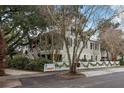 Two-story home with white picket fence, landscaping, and American flag at 209 Bennett St, Mount Pleasant, SC 29464