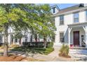 White house with red door, landscaping, and a walkway at 234 Oak Park St, Summerville, SC 29486