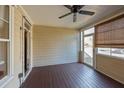 Relaxing screened porch offers a peaceful outdoor space with wood flooring and a ceiling fan at 2971 Treadwell St St, Mount Pleasant, SC 29466