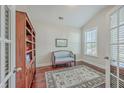 Home office with hardwood floors, built-in shelves, and a comfortable couch at 311 Calm Water Way, Summerville, SC 29486